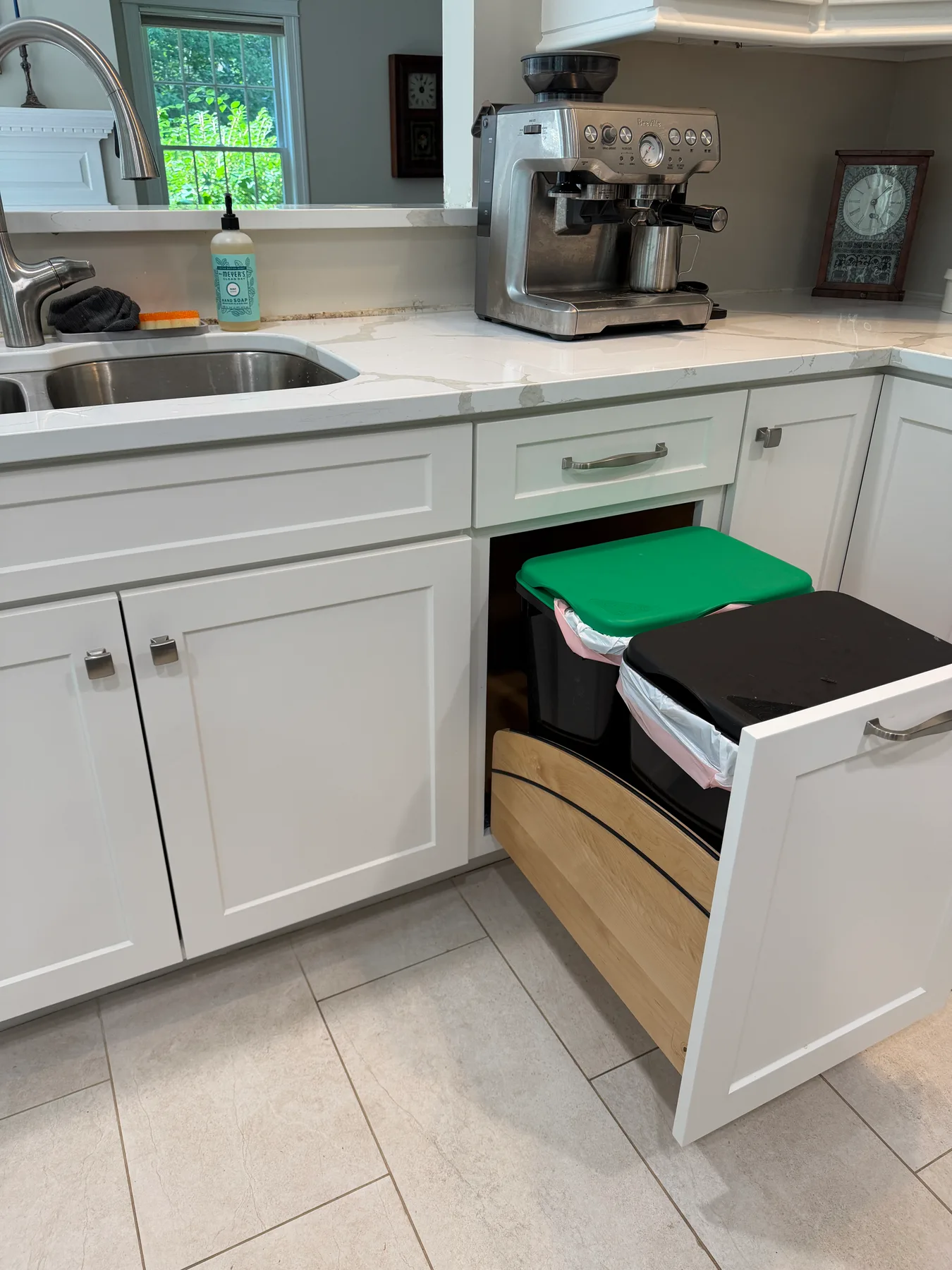 Pull-out trash and recycling bin storage detail beneath the counter